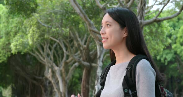 Young Woman taking photo on camera in the park