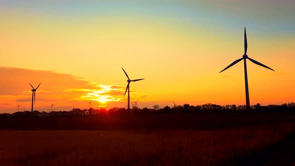 Nice sunset over wind turbines, Austria, ecology concept