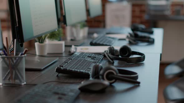 Empty Call Center Office with Computers and Audio Headsets