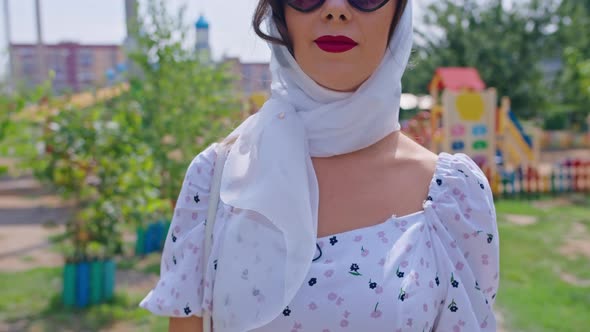 Young Happy Woman in White Dress Walks Down the Alley Pinup