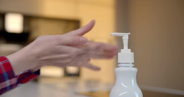 Close Up of Woman Pushing Dispenser with Antiseptic Cleaning Hands