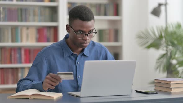 Excited Young African Man Shopping Online on Laptop