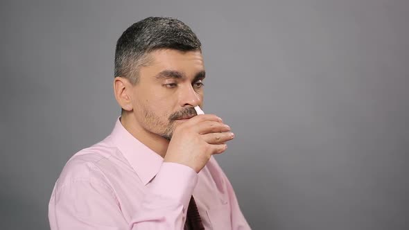Sick Man With Beard Using Nasal Spray, Allergy, Medicine and Health Care