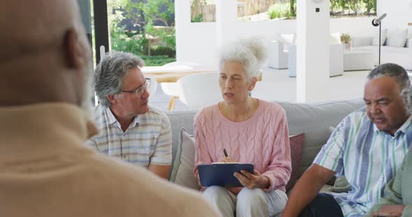 Senior diverse people at meeting talking at retirement home