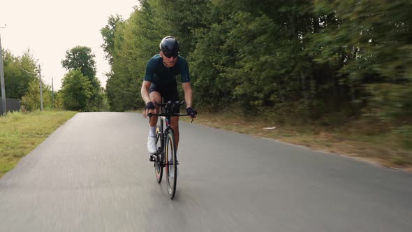 Road biking cyclist man training on bike.