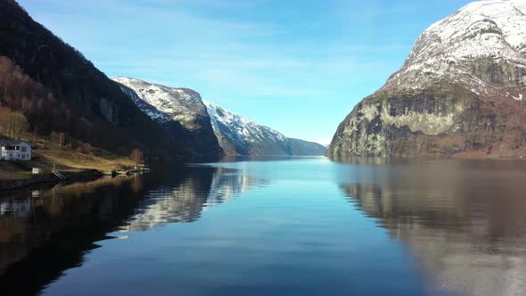 Beautiful winter morning in Aurlandsfjord Norway -Aerial close to sea surface outside undredal betwe