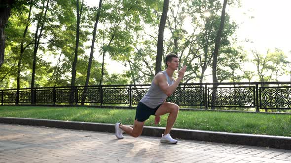 Athletic Man Warming Up with Back Lunge Exercise Outdoor Sport