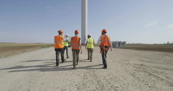 Anonymous Colleagues Walking Towards Windmill