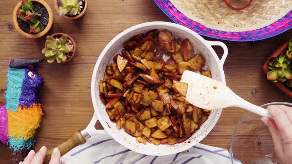 Flat lay. Step by step. Frying red apples with brown sugar for filling to make empanadas.