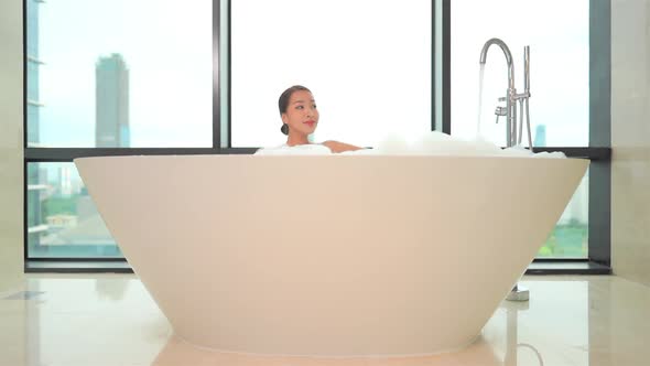 Young asian woman relax in bathtub