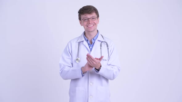 Happy Young Handsome Man Doctor Clapping Hands
