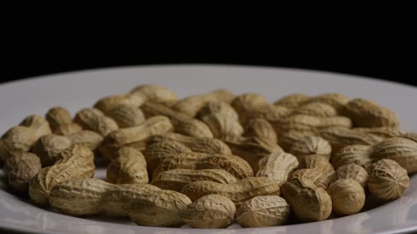 Cinematic, rotating shot of peanuts on a white surface - PEANUTS 012