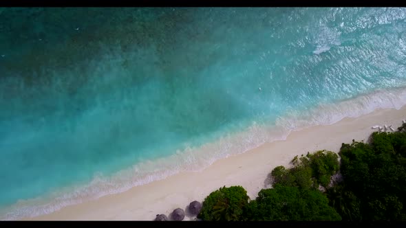 Aerial above nature of tranquil tourist beach lifestyle by blue sea and bright sand background of a 