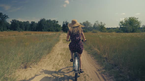 Cyclist Lady Moving On Bike On Countryside. Woman Cyclist Riding On Bicycle In City Park.