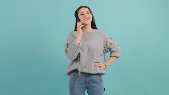 Woman Talking on Phone, Looks at Watch and Understands That She Is Late.