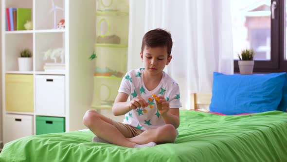 Happy Little Boy Playing with Airplane Toy at Home 4