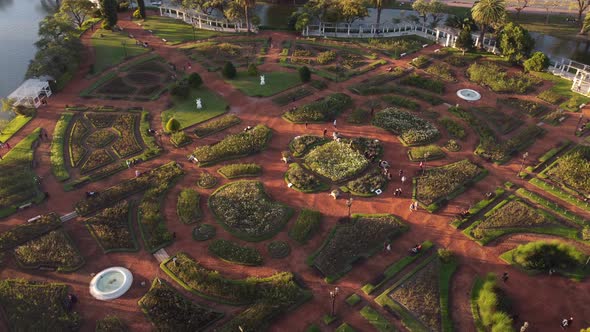 Orbit aerial view of Rosedal de Palermo park during sunset