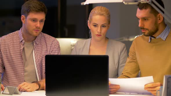 Business Team with Laptop Working at Night Office