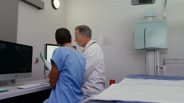 Surgeon and colleague discussing medical reports