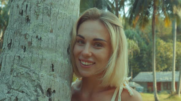 Young Blonde Standing Contemplating Tropical Rainforest Sunset Light Coming From Above