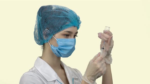 Portrait of a Young Woman Doctor Preparing To Make an Injection
