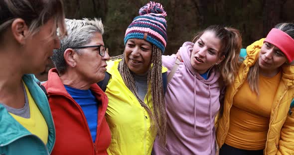 Multiracial women having fun during trekking day into the wood