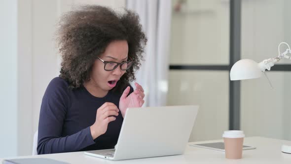 African Woman Feeling Disappointed While Using Laptop