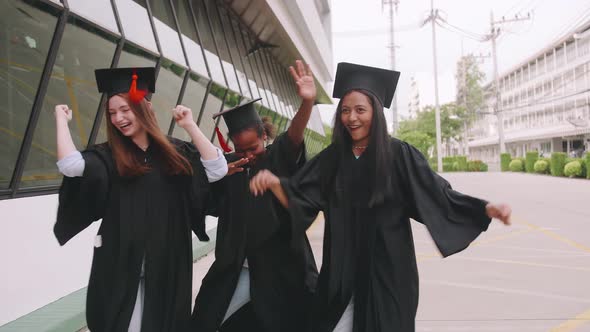 Group of friends having fun celebrating their graduation by dancing together.