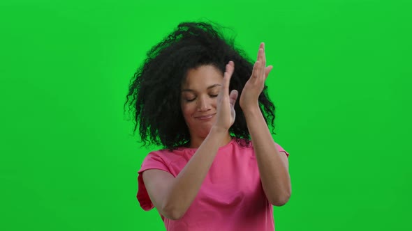 Portrait of Young Female African American Looking at Camera and Clapping Her Hands Enthusiastically