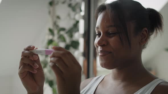 Close up of African-American stressed woman  waiting for pregnancy test results. Shot with RED heliu