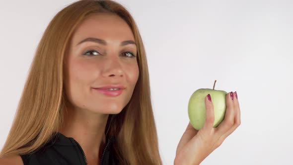 Happy Woman Smiling Cheerfully Holding an Apple