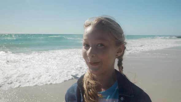 Young girl making funny faces at the beach