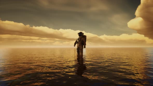 Spaceman in the Sea Under Clouds at Sunset alt