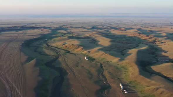 Yurts Between Montains at Sunset in Mongolia