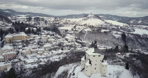 Aerial shot of a New Castle in Mining town Banska Stiavnica in winter, Cloudy