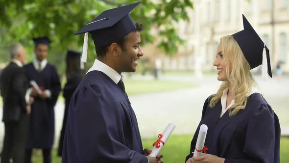 Graduate Students with Diplomas Talking, High-Fiving Each Other, Convocation Day