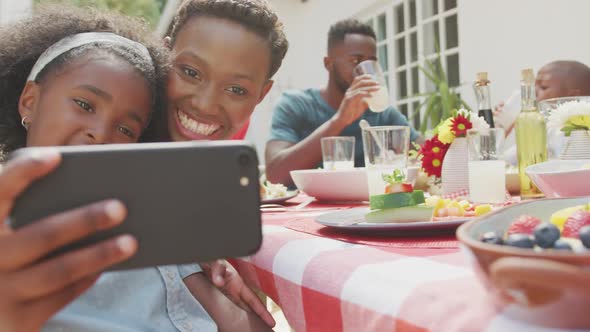 Happy family eating together at table