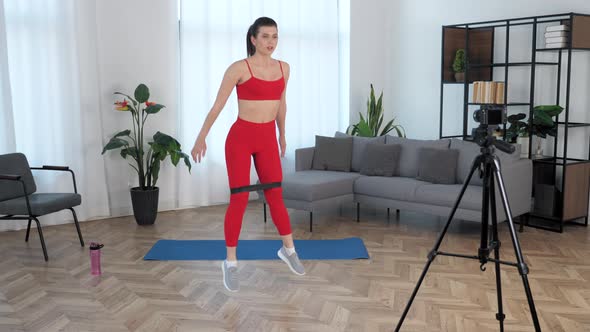 Sport Muscular Woman Records Online Course Lesson on Camera Workout at Home