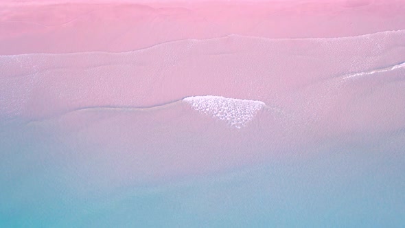 4K Aerial view top view of drone, blue sea waves and beautiful pink sand beach.