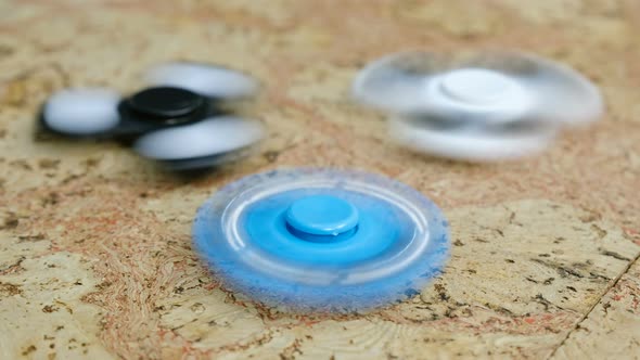 Three Spinner Spinning on a Wooden Table