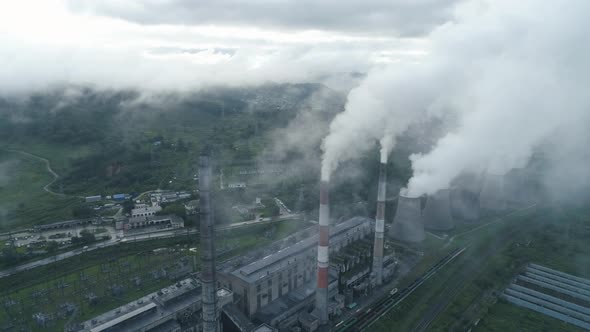 Aerial Drone View of Smoking Pipes and Cooling Towers of Coal Thermal Power Plant