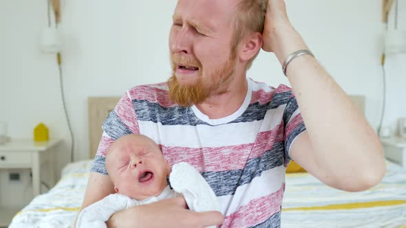 father with a baby in their arms screaming, a man clutching his head