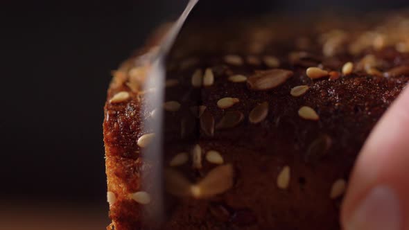 Close Up of Knife Cutting Homemade Bread