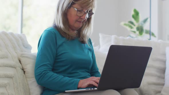 Senior woman using laptop at home