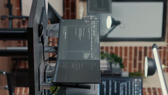Vertical Video Computer Screens Running Programming Code in Empty Software Developing Agency Office