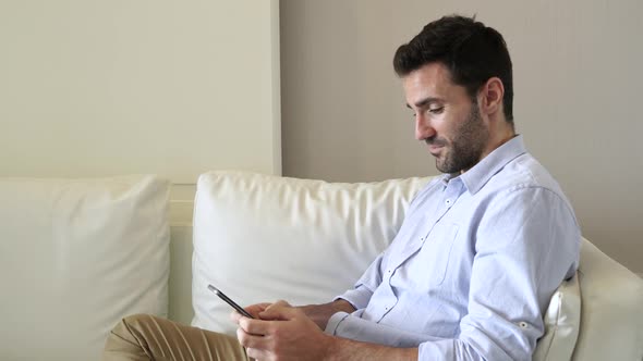 Man Texting On Smartphone