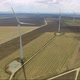 Aerial shot of road going through wind farm - VideoHive Item for Sale