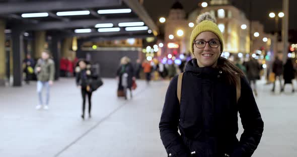 Authentic shot of woman walking in the city at night in London