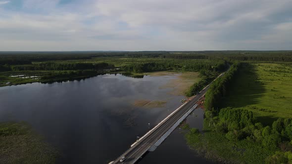 Aerial View of Bridge Near Lake and Field Under Water in Countryside