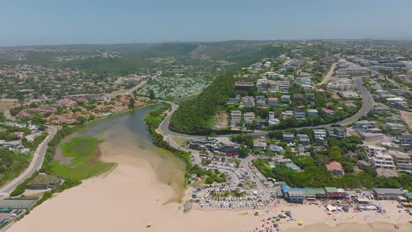 River Flowing Through Coastal Town and Its Estuary to Sea at Sand Beach